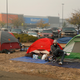 People sit by their tents at a makeshift encampment outside a Walmart store for people displaced by the Camp Fire.
